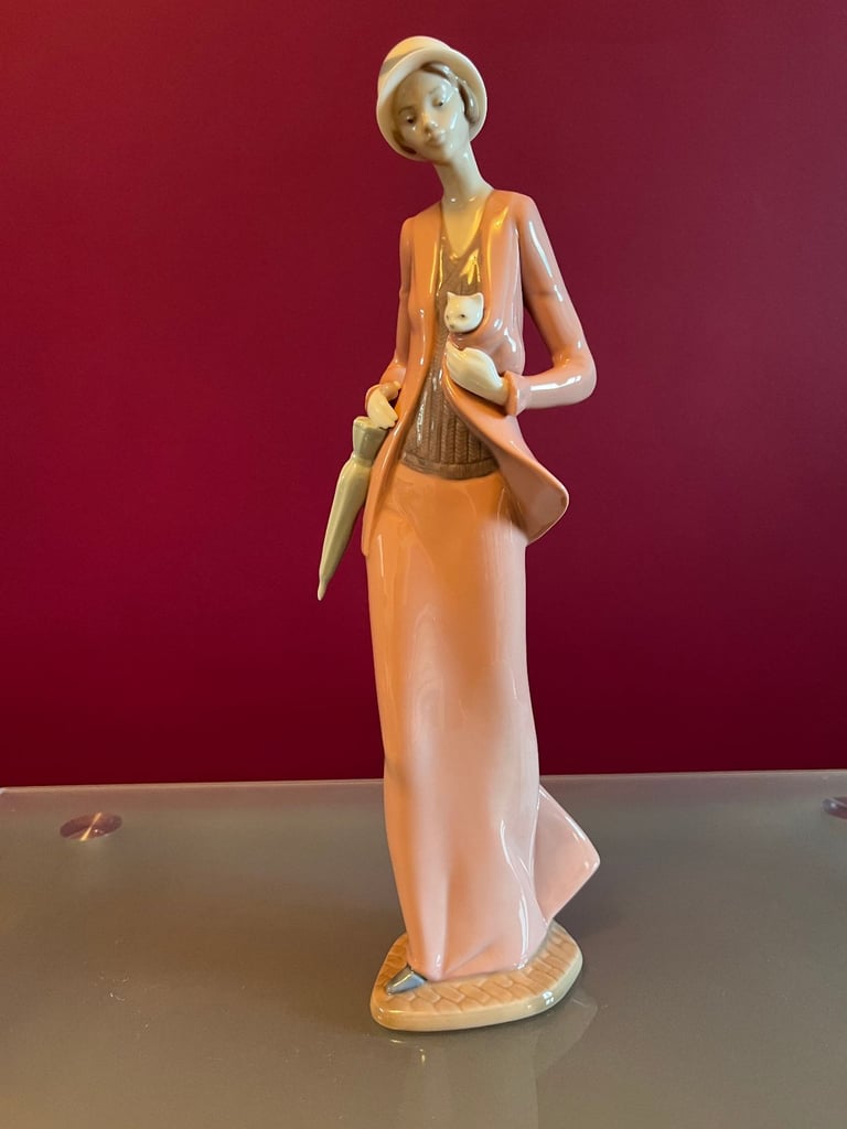 NAO Figurine - Woman, in 1920s outfit, carrying a cat & umbrella