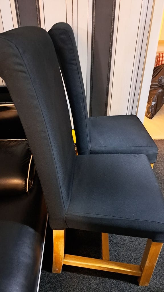 Two black solid chairs. 