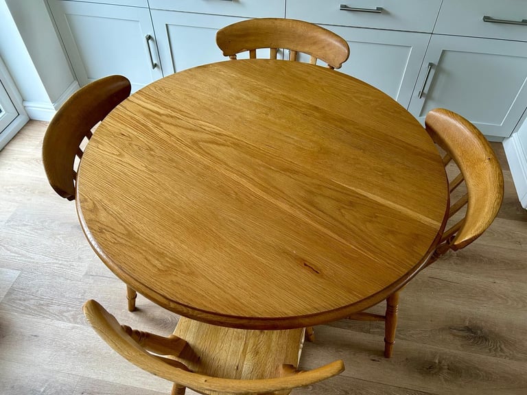 Solid oak dining table and four chairs