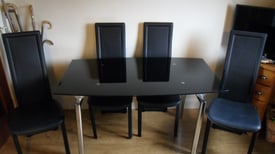 Black smoked glass extending dining table and 4 chairs