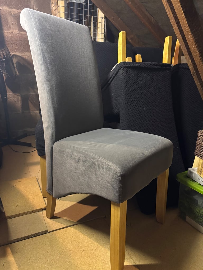 8 like new dining chairs with black covers 