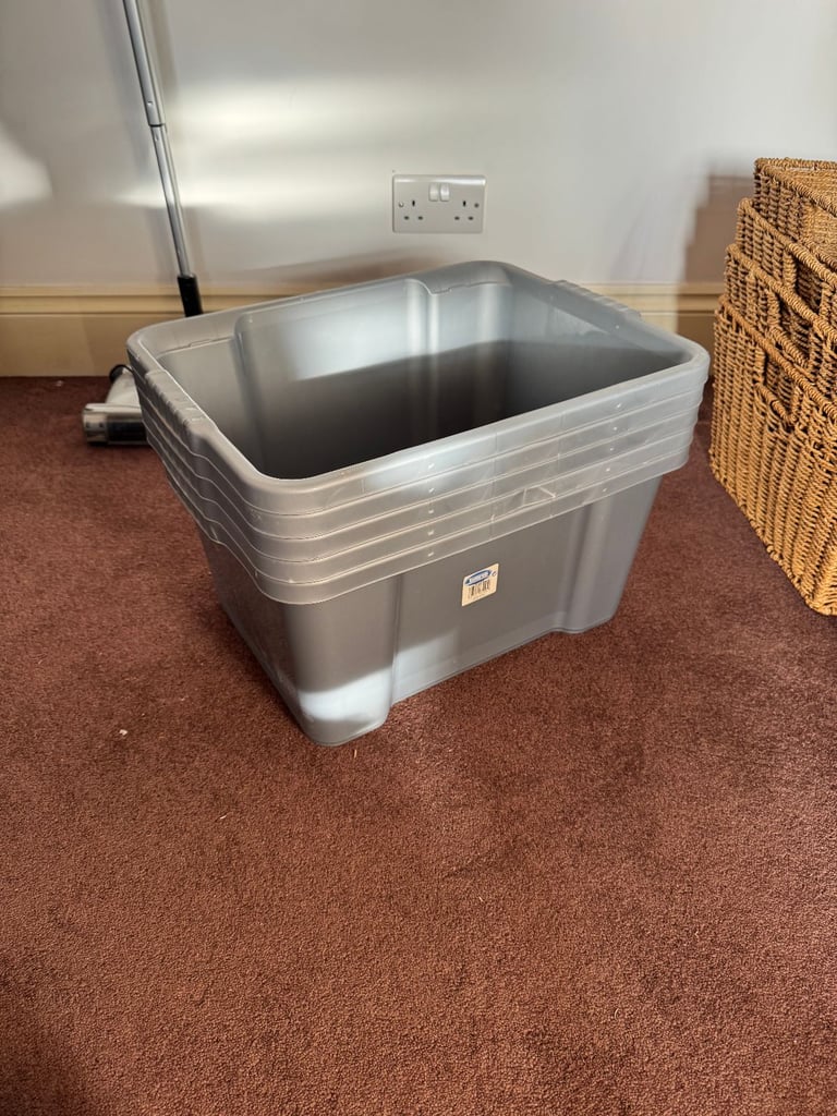 Five grey plastic storage boxes