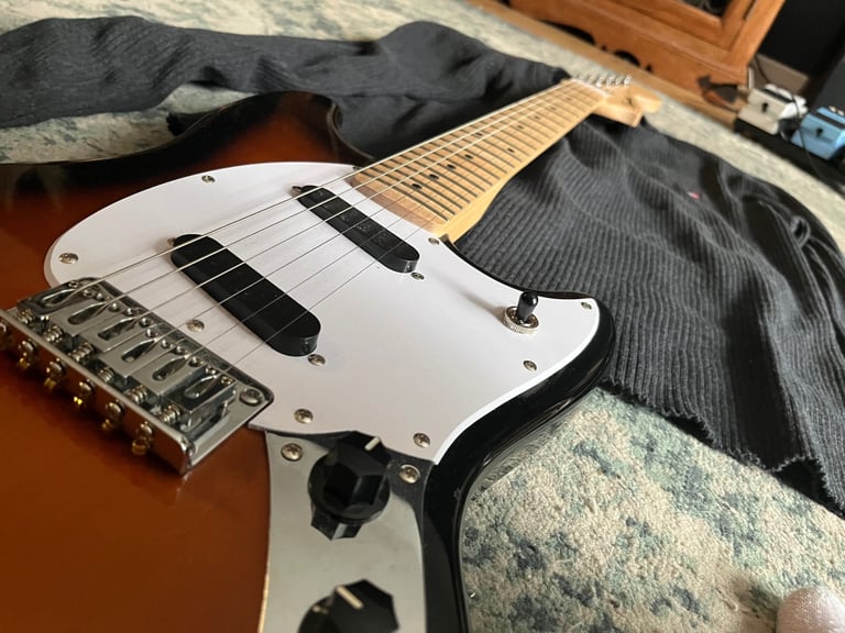 Squier by fender mustang electric guitar in sunburst