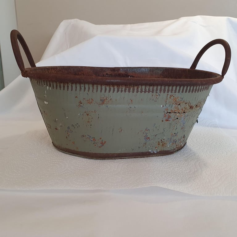 Rustic metal bath-shaped trough, including some pine cones and other Christmas decoration material