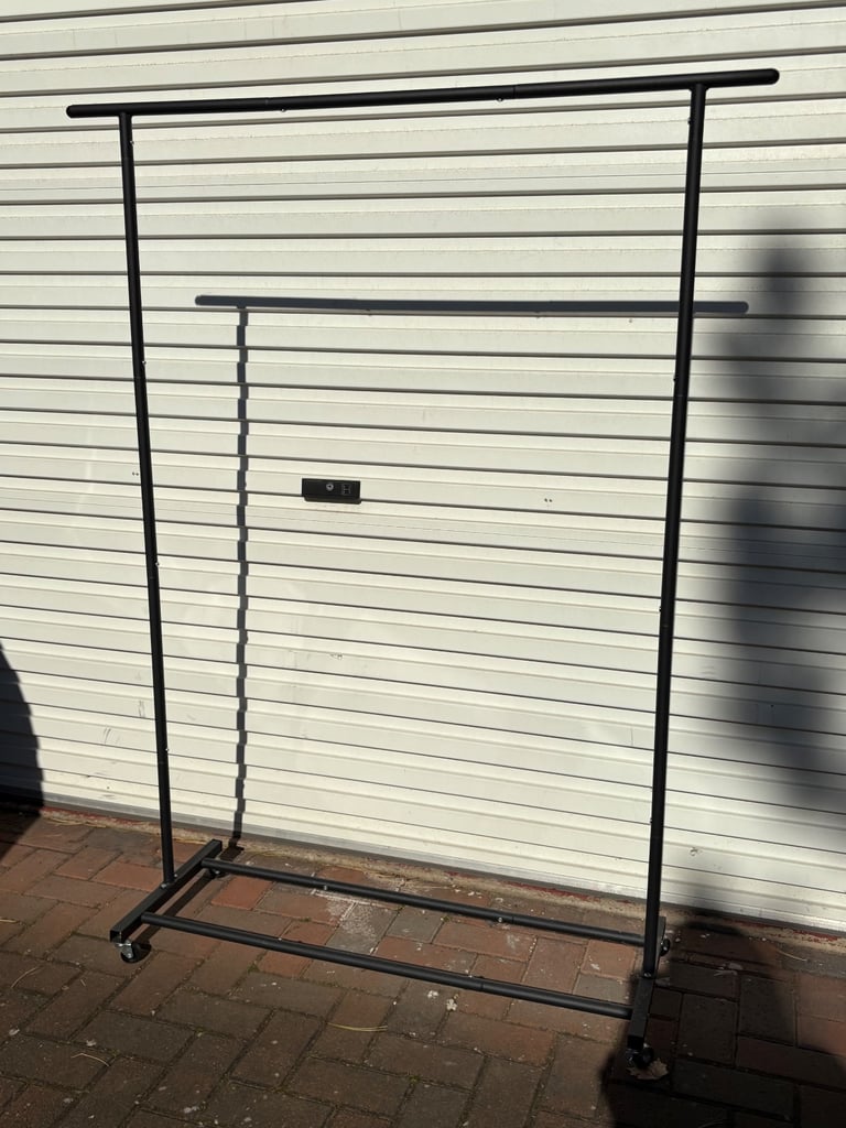 Metal clothes hanging rail on wheels