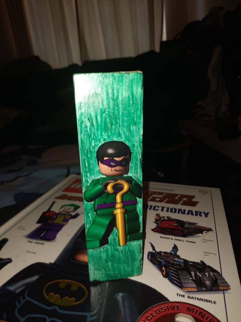 1960 & 2006 batman lego minifigures in a display case 