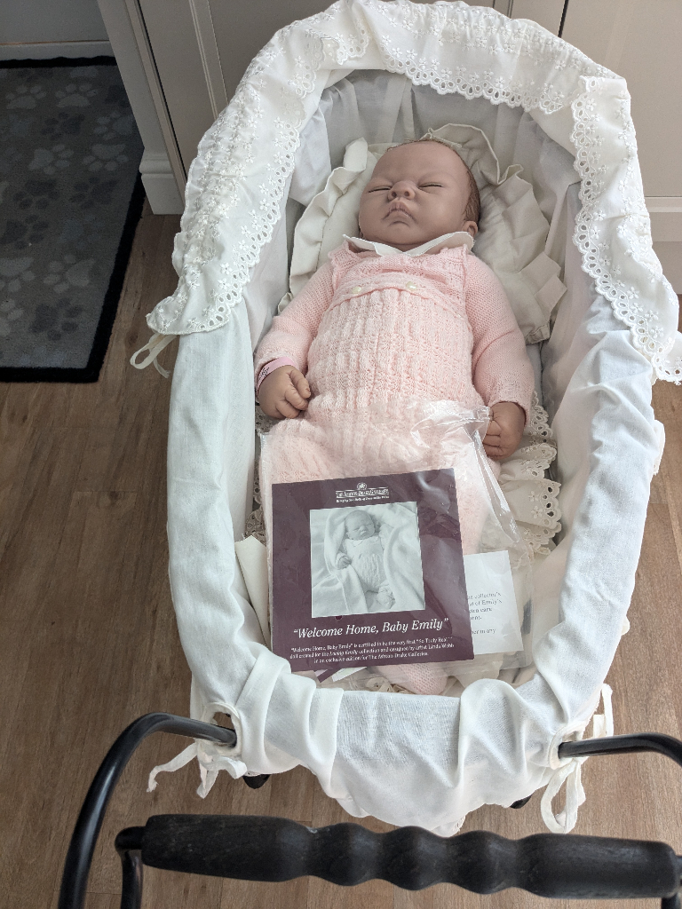image for Reborn doll with wicker pram