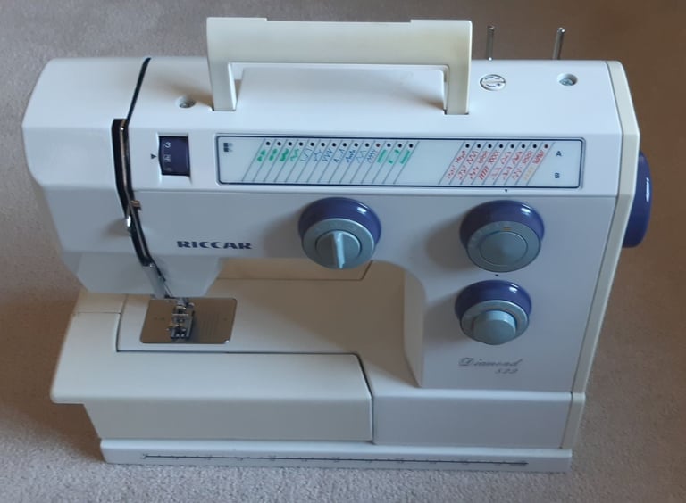 Riccar Diamond 829 Electronic Sewing Machine with foot pedal, cover and manuals.