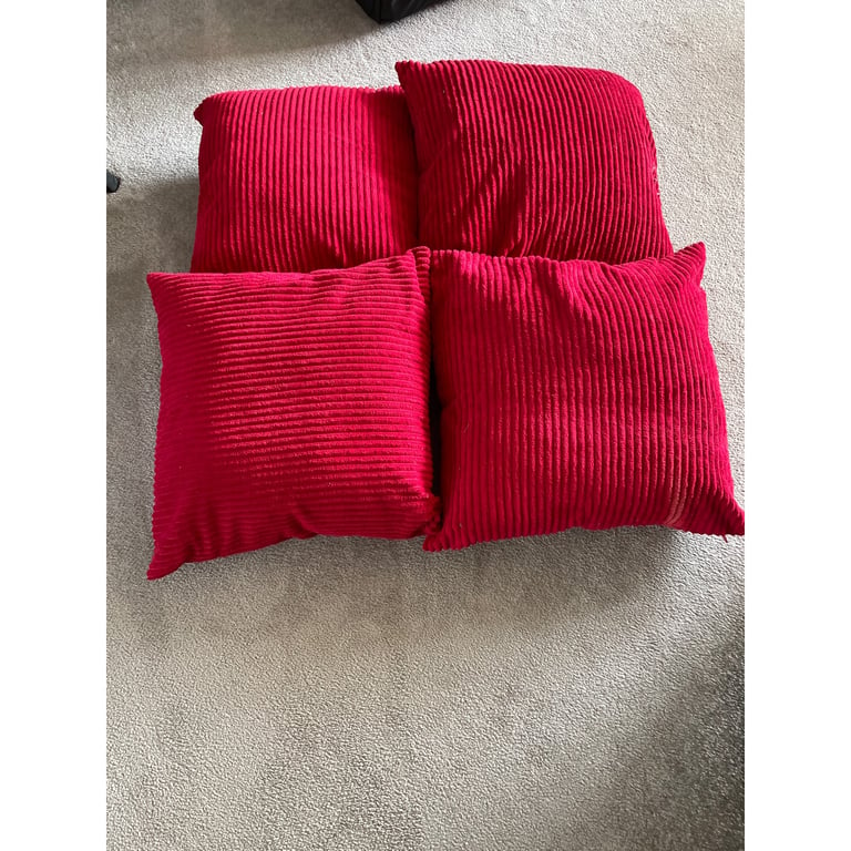 Four large red cushions 