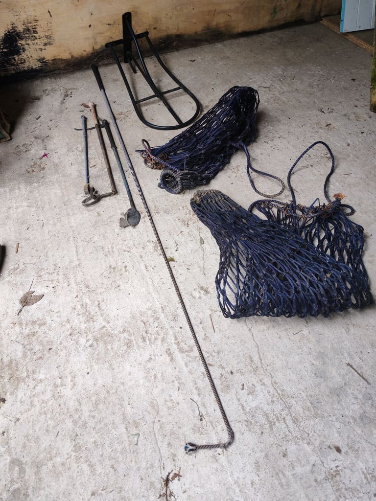Saddle rack, two hay nets, lunge whip, riding crops