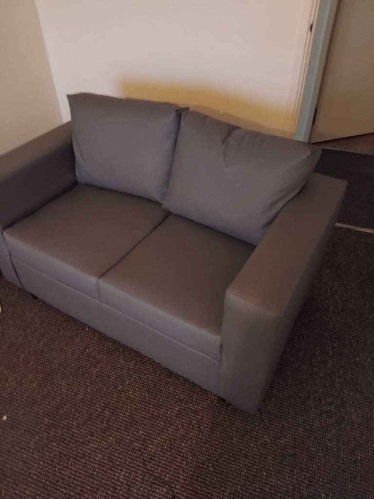 Brand new small 2 seater grey leather couch