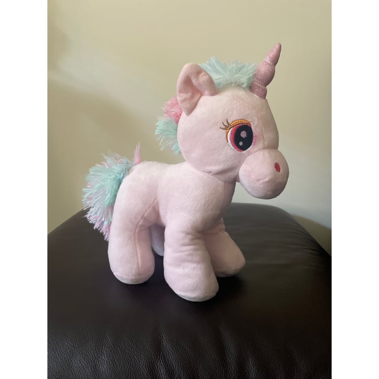 A cuddly pink Unicorn soft toy