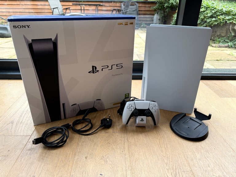 image for PlayStation 5 (original), boxed with DualSense controller and dual-controller charger 