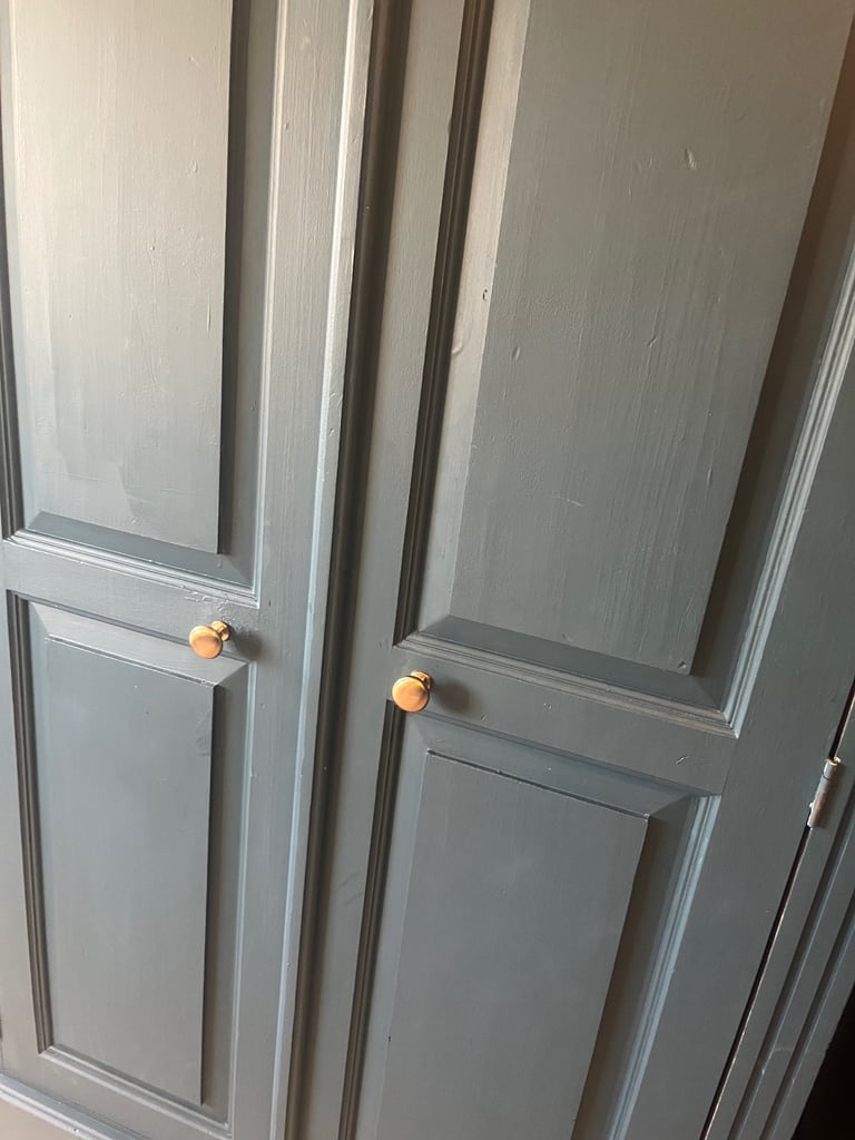 Wardrobe and drawers set navy blue , chunky wood gold knobs . 