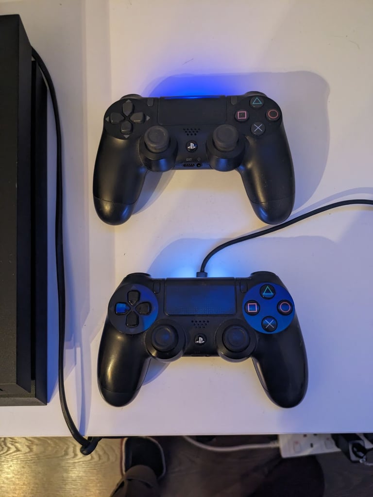 PlayStation 4 console and two controllers 