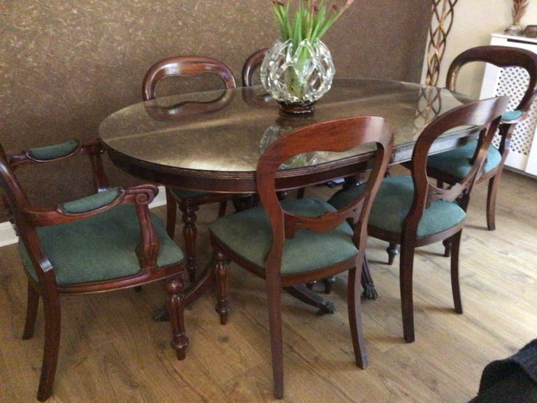 A vintage dining table and 6 chairs made from oak and wood veneer 
