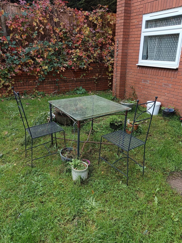 Cast metal and Glass Top Garden Table and Two Chairs