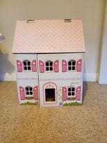 Wooden dolls house with lots of furniture and accessories 