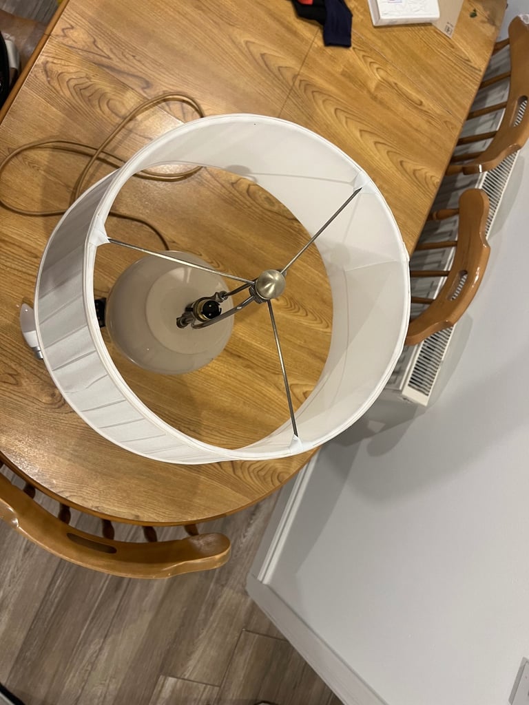 Pair of Dunelm Off white ceramic lamp with brass fixtures .