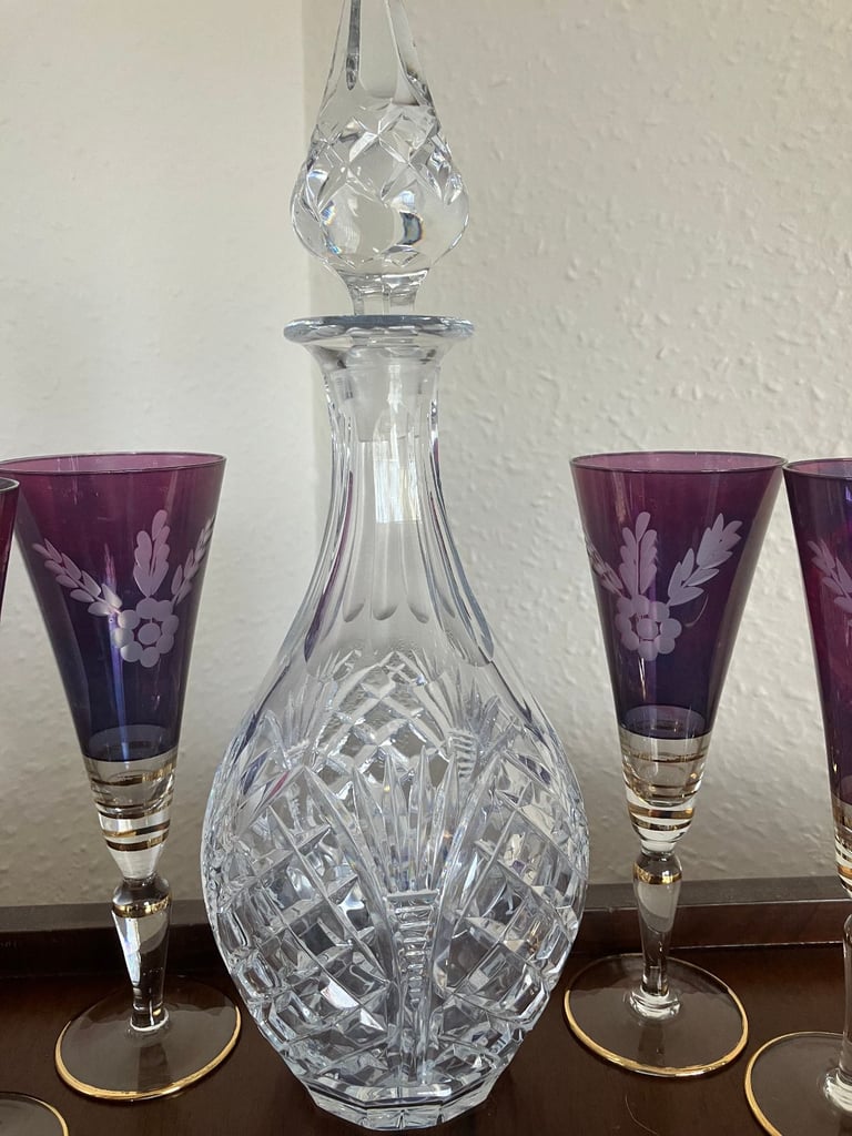 Heavy glass decanter and six vintage wine glasses.