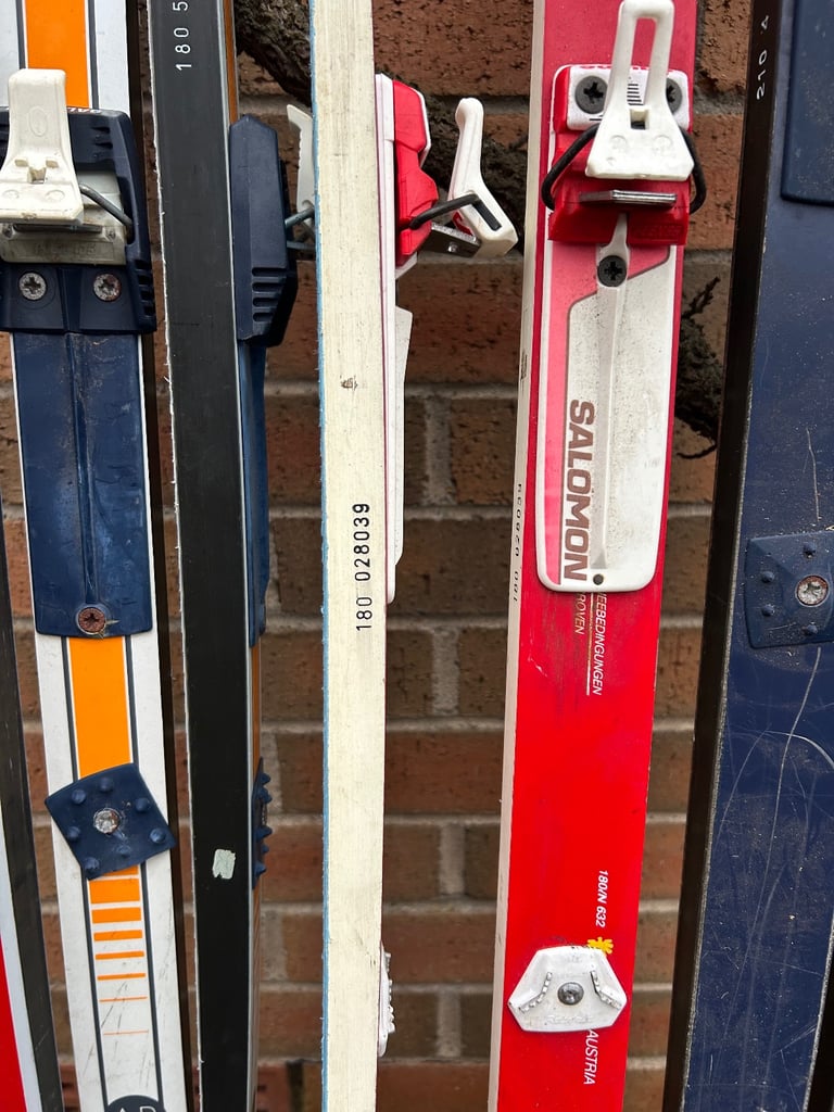 Various cross country skis, poles and boots