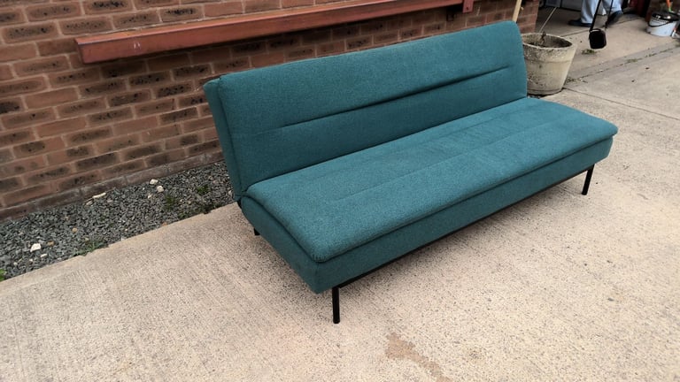 green 2 seater sofa that folds down to be a sofa bed 
