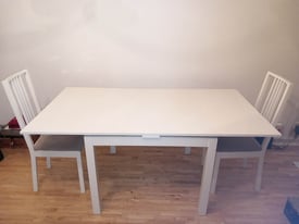 Ikea Bjursta wooden extendable table and two chairs