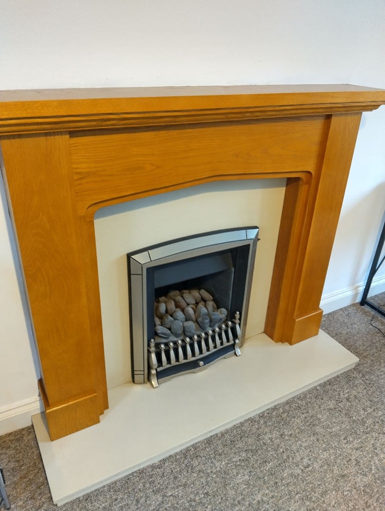 Gas fire with hearth and wood surround
