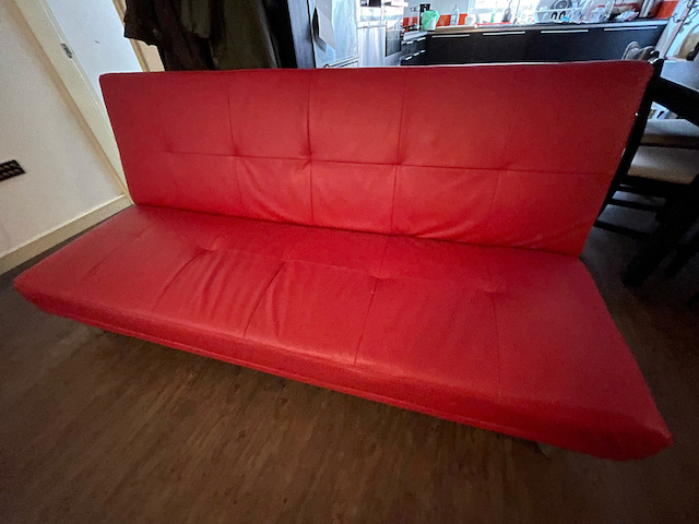 Faux leather sofa bed - red 'click-clack' style - FREE