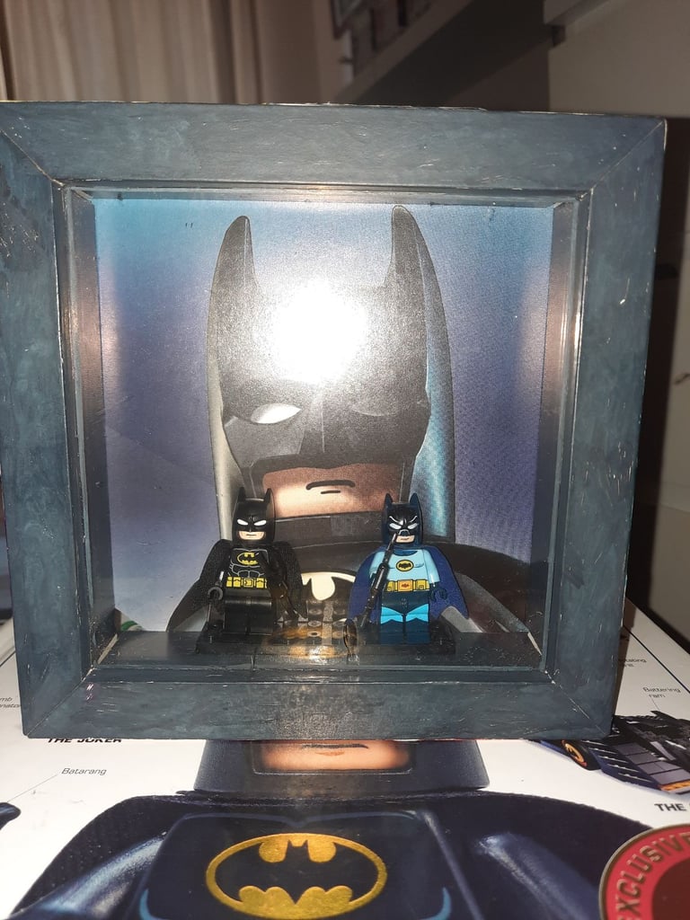 image for 1960 & 2006 batman lego minifigures in a display case 