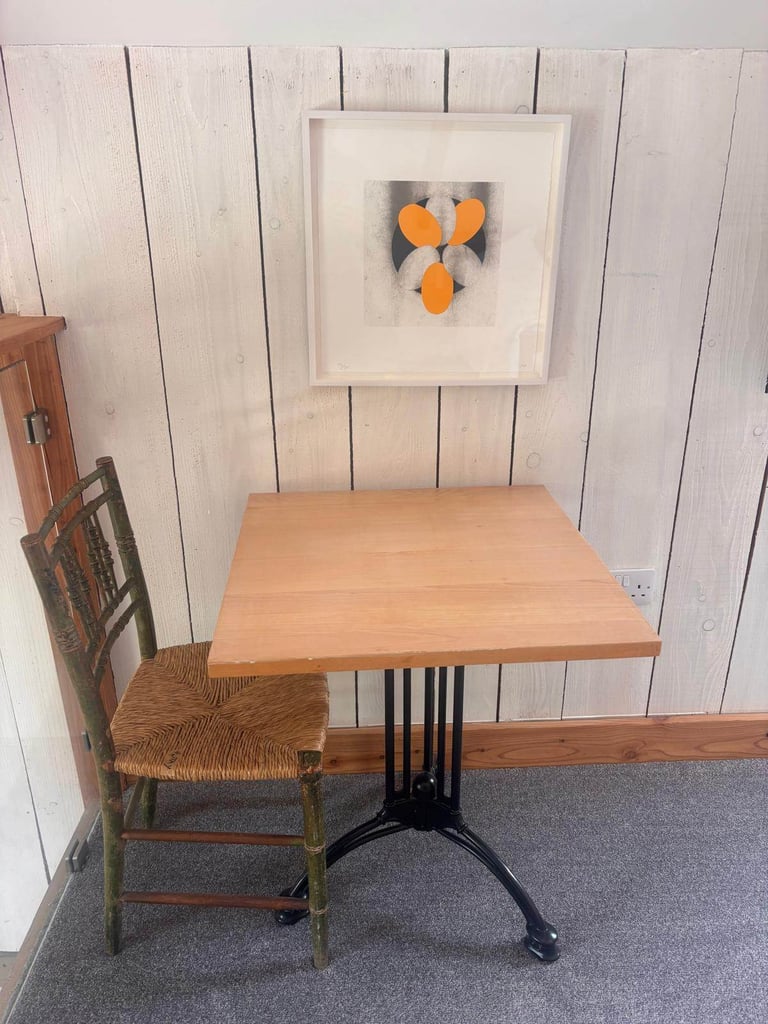 Eleven lovely cafe style tables with wooden tops and vintage style metal bases.