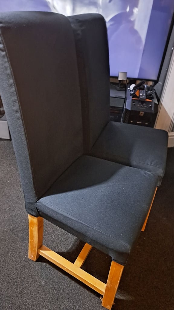 Two black solid chairs. 