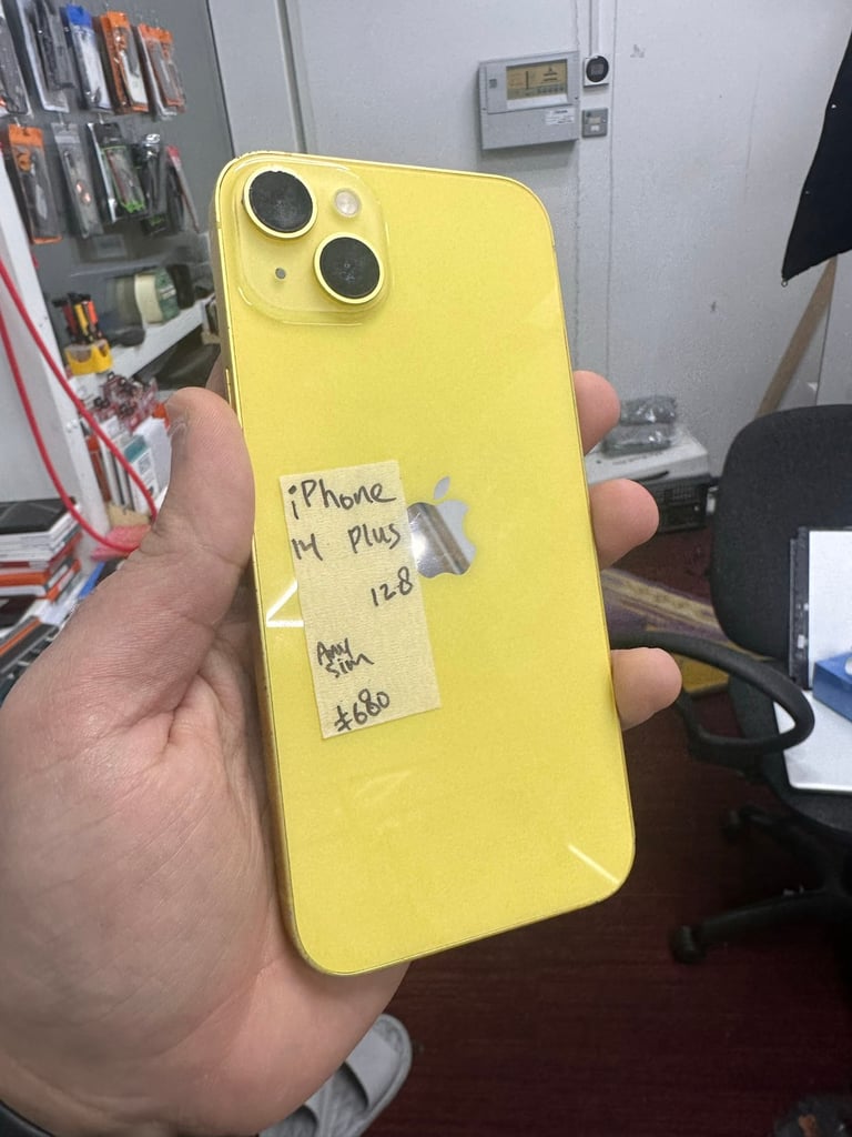Yellow iPhone 14 Plus in good condition at phone shop 