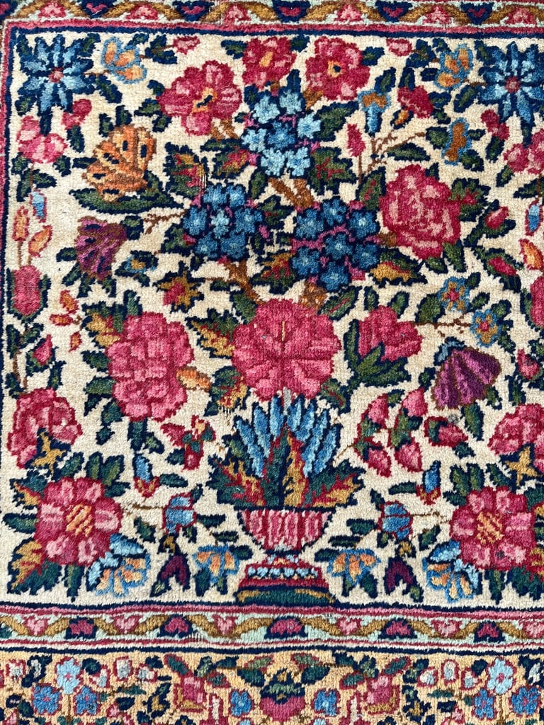A pair of Antique Kirman mats 