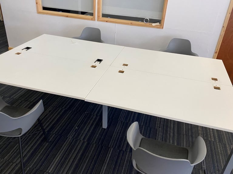 White bank of 4 used office bench desks 1400mm per desk