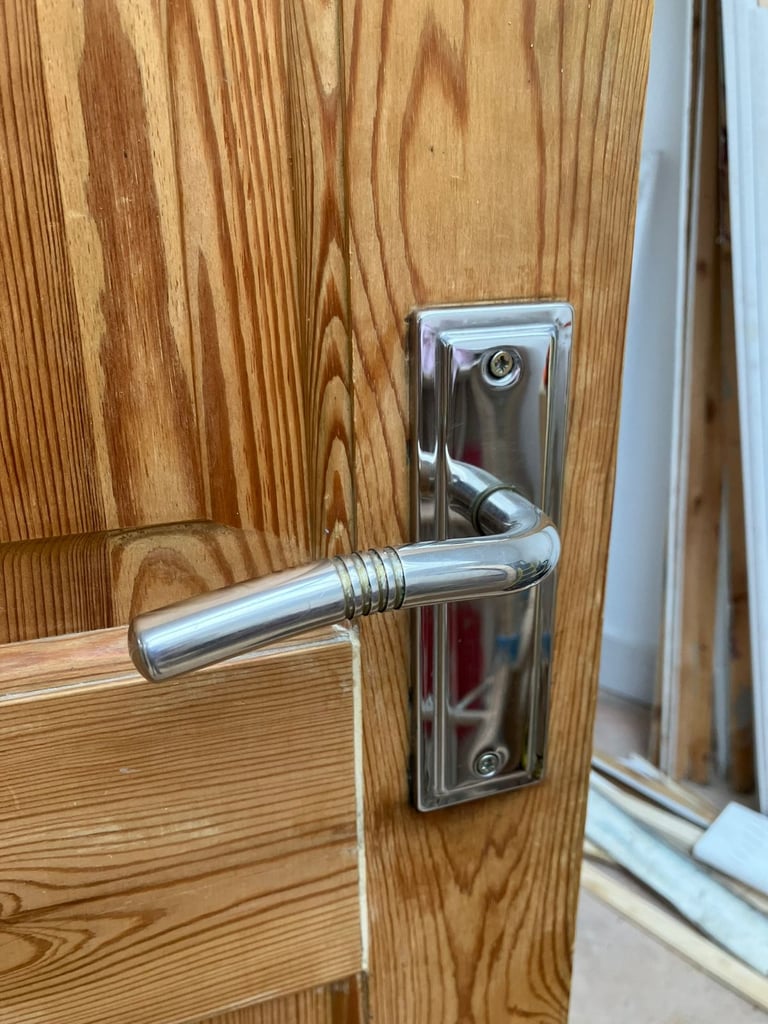 solid pine 4 panel door with silver coloured handle 