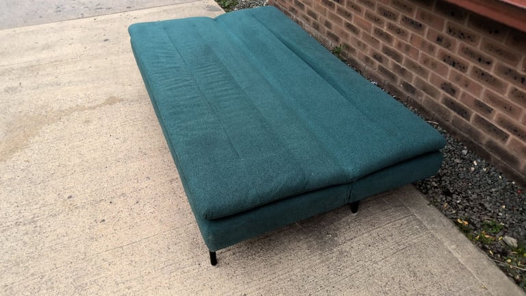 green 2 seater sofa that folds down to be a sofa bed 