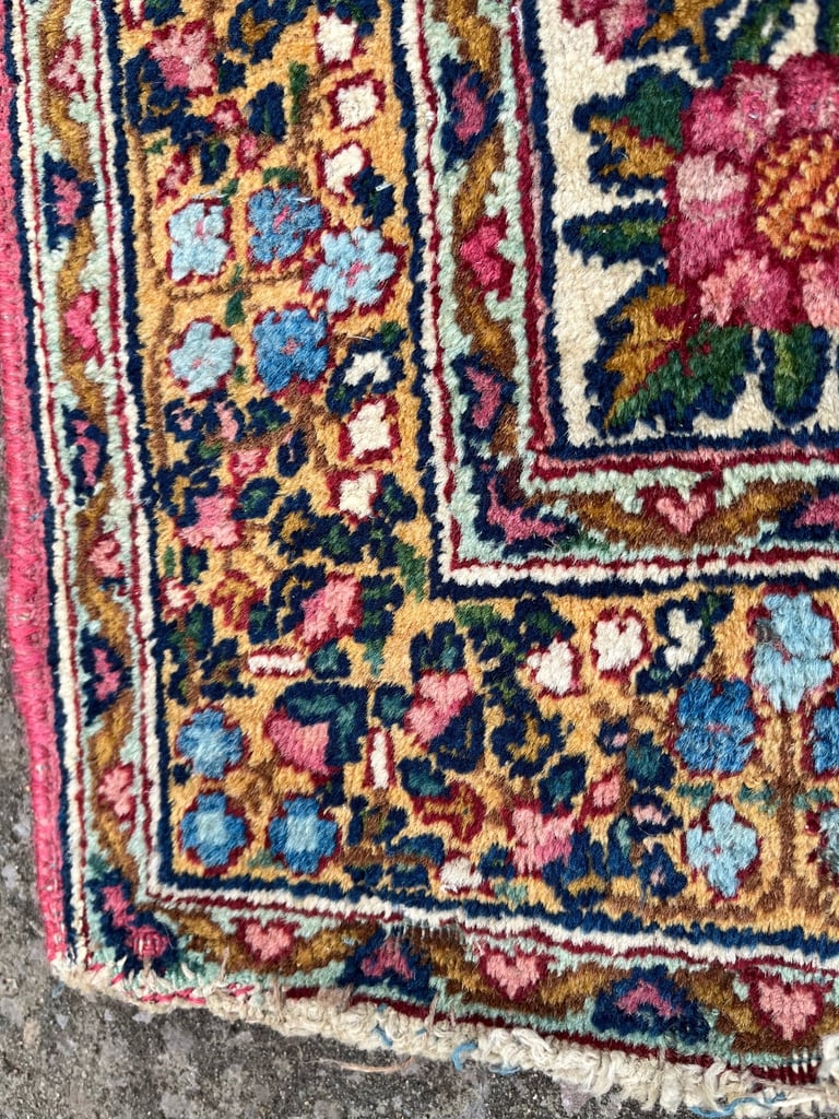 A pair of Antique Kirman mats 