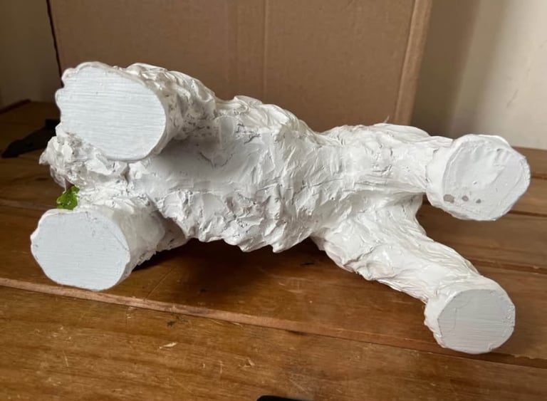 White resin Westie dog ornament wearing a scarf. New in box  Size height 26cm width 31cm depth 14 cm