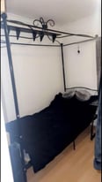 Black four poster/canopy bed with new mattress, dismantled and ready to go 