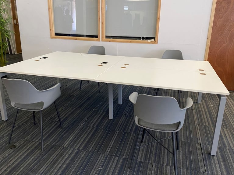 White bank of 4 used office bench desks 1400mm per desk