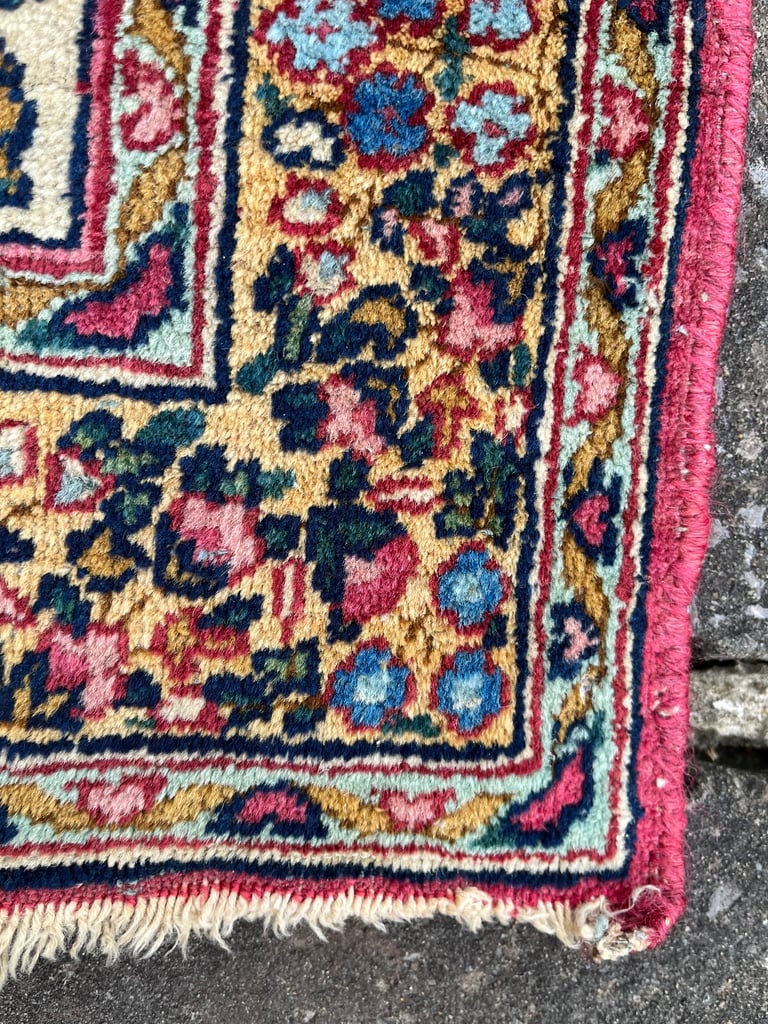 A pair of Antique Kirman mats 