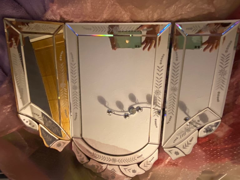 Tri-fold mirror with ornate edge 