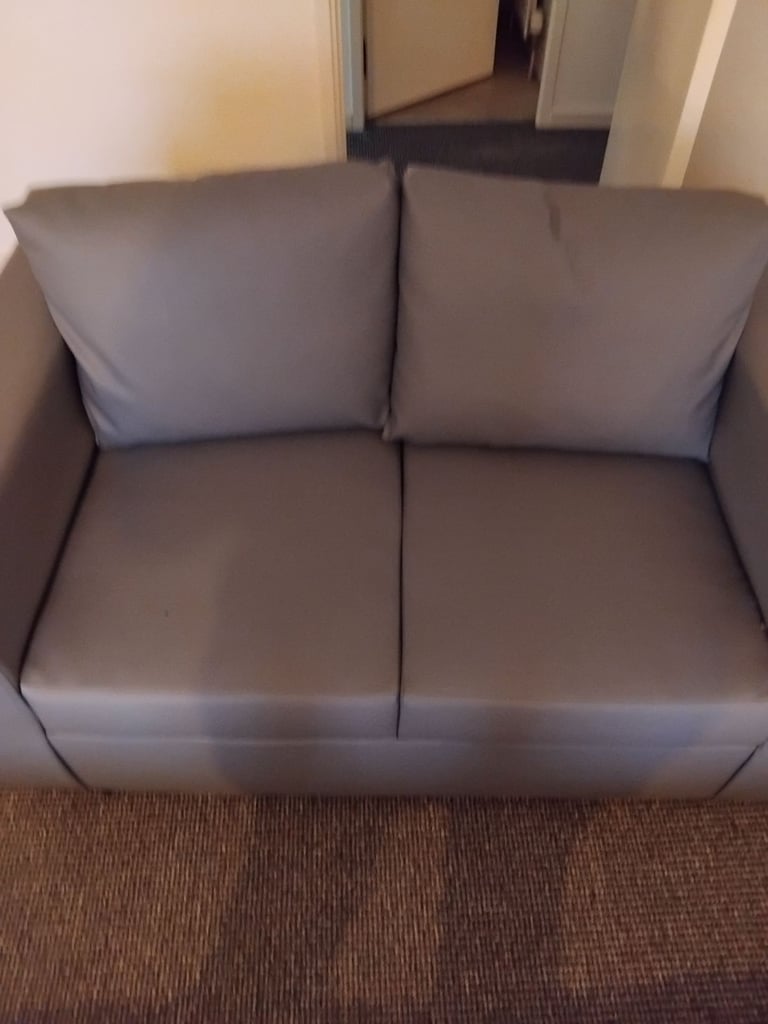 Brand new small 2 seater grey leather couch