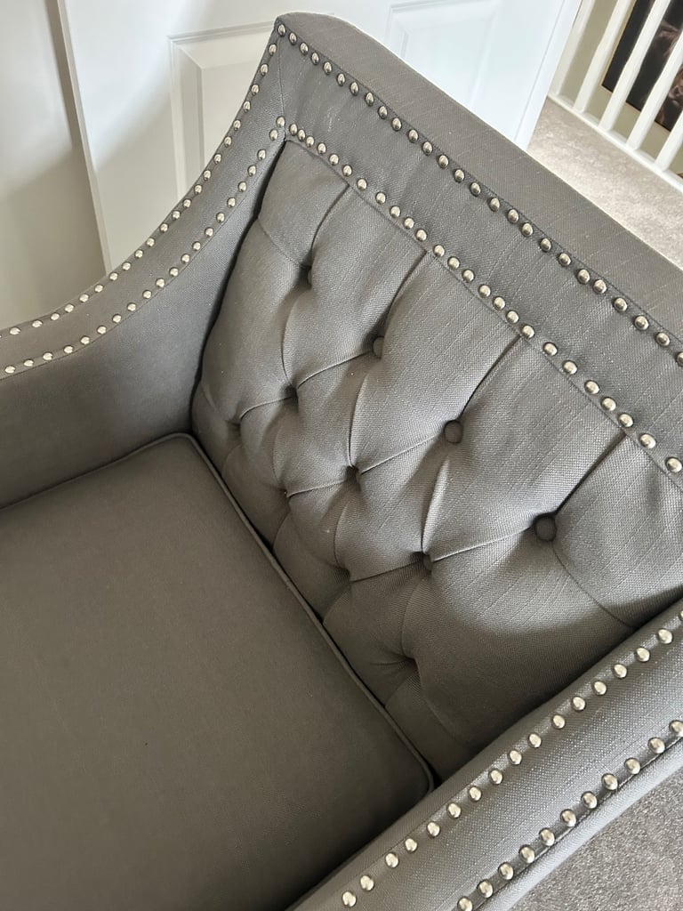 Grey studded armchair