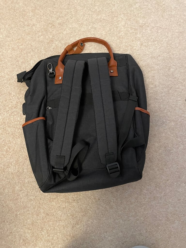 Waterproof black backpack with brown handles etc