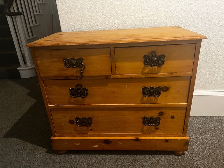 Antique pine chest of drawers with butterfly brass handles