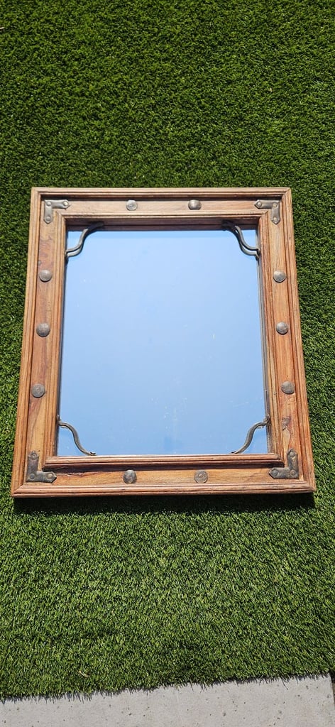 Wooden mirror with metal stud detailing