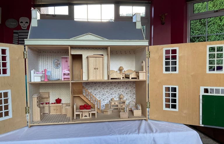 Handmade wooden dolls house with furniture and family