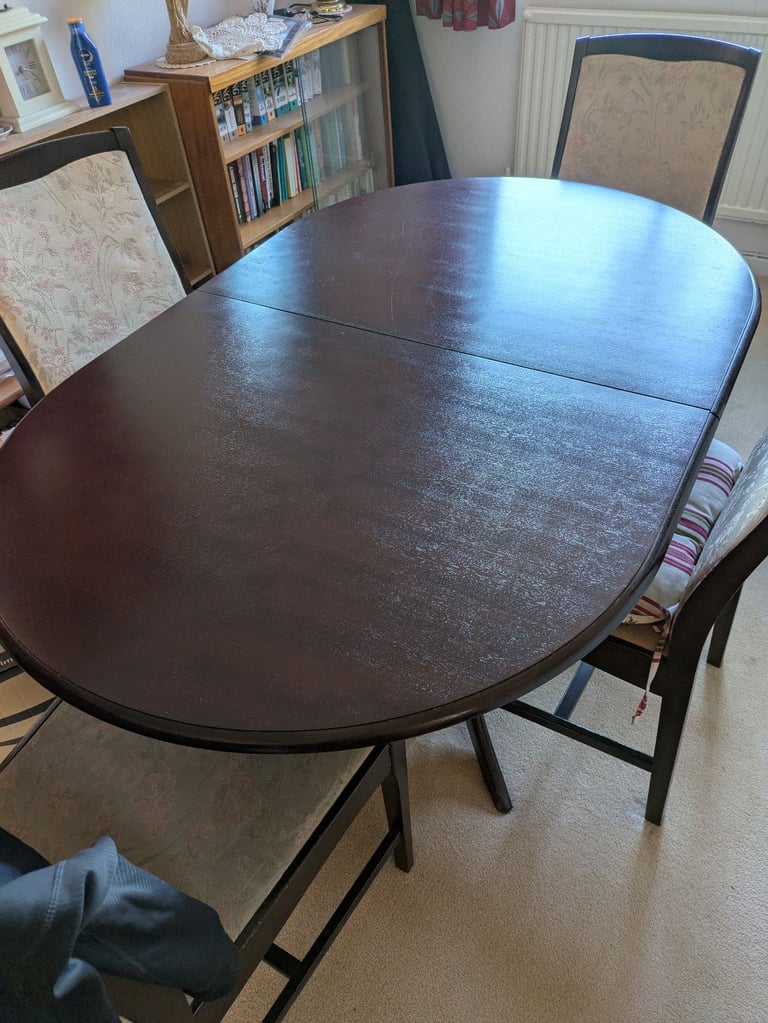 Stag Minstrel dining table and four chairs